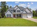 Charming two-story home featuring a manicured lawn and inviting red front door at 87 Pelican Ct, Sanford, NC 27332