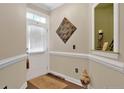 Welcoming entryway featuring decorative wall accents, wainscoting, and hardwood floors at 89 Revolutionary Rd, Cameron, NC 28326