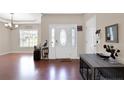 Welcoming foyer with hardwood floors, tray ceiling, and decorative accents at 175 Revere Way, Cameron, NC 28326