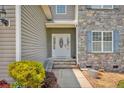 Inviting front entrance featuring a decorative glass door and stone accents at 175 Revere Way, Cameron, NC 28326