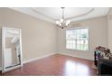 Cozy living room with tray ceiling, large window, and hardwood flooring at 175 Revere Way, Cameron, NC 28326