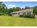 Well-maintained ranch style house with a covered front porch and lush green lawn at 2901 Cheshire Dr, Sanford, NC 27332