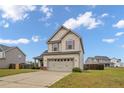 Inviting two-story home with a spacious driveway and an appealing, symmetrical design at 110 Summerseat Way, Bunnlevel, NC 28323