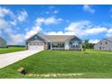 Charming single-story home featuring stone accents, a two-car garage, and a beautifully manicured lawn at 127 Camp Rock Rd, Lillington, NC 27546