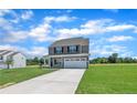 Beautiful two-story home with attached two car garage and large front lawn at 136 Camp Rock Rd, Lillington, NC 27546