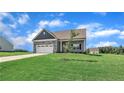 Single-Gathering home with a well-manicured lawn and landscaping at 155 Camp Rock Rd, Lillington, NC 27546