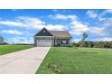 Single-Gathering home with a well-manicured lawn and a two-car garage on a sunny day at 155 Camp Rock Rd, Lillington, NC 27546