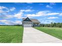 Single-Gathering home with a well-manicured lawn and a long driveway on a sunny day at 155 Camp Rock Rd, Lillington, NC 27546
