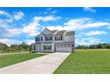 Beautiful two-story home with a classic design, double garage, and lush green lawn at 158 Camp Rock Rd, Lillington, NC 27546