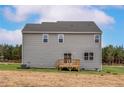 Rear view of a home with gray siding and a small wooden deck at 158 Camp Rock Rd, Lillington, NC 27546