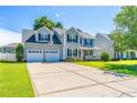 Attractive two-story home with a spacious driveway, two-car garage, and neatly maintained front yard at 191 Trenton Pl, Cameron, NC 28326