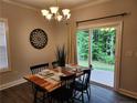 Cozy dining area with wood table and sliding glass doors opening to the backyard at 207 Southwick Ct, Sanford, NC 27332
