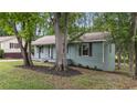 Quaint single-story home featuring a covered porch and verdant landscaping at 2308 Keith Dr, Raleigh, NC 27610