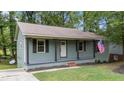 Inviting single-Gathering home showcasing a covered porch, a manicured lawn, and classic curb appeal at 2308 Keith Dr, Raleigh, NC 27610