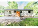 The backyard has a concrete patio and an orange door for outdoor living and entertaining at 2327 Dewitt St, Sanford, NC 27330