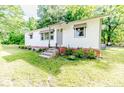 Charming home featuring brick accents, freshly landscaped flowerbeds, and concrete steps to the front door at 2327 Dewitt St, Sanford, NC 27330