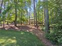 Idyllic home nestled among mature trees, offering a sense of privacy and natural beauty at 3103 Royal Pines Dr, Sanford, NC 27330