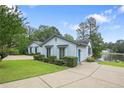 A serene view of a home with lakeside access, lush landscaping, and a spacious driveway at 38 East Lndg, Sanford, NC 27332