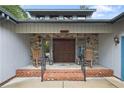 Inviting front porch with stone accents, a brick entryway, and classic rocking chairs at 38 East Lndg, Sanford, NC 27332