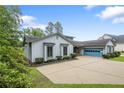 A charming home with a spacious driveway and a bright blue garage door at 38 East Lndg, Sanford, NC 27332