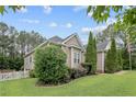 Well-maintained home exterior boasts a green lawn, shrubs, trees, trimmed evergreen shrubs, and tidy landscaping at 45 Remington Hills Dr, Bunnlevel, NC 28323