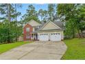 Charming two-story brick and siding home featuring a well-maintained lawn, two-car garage, and blue front door at 46 Wateredge Ln, Sanford, NC 27332