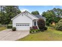 Charming single-Gathering home featuring a two-car garage, brick accents, and mature landscaping in a quiet neighborhood at 6301 Mockingbird Ln, Sanford, NC 27332