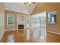 Spacious living room featuring a fireplace, vaulted ceiling, and abundant natural light at 177 Lamplighter Way, Spring Lake, NC 28390