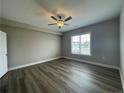 Bright bedroom with a ceiling fan, large window, and wood look flooring at 240 Gallery Dr # 301, Spring Lake, NC 28390