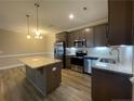 A modern kitchen featuring stainless steel appliances, granite countertops, and a kitchen island at 240 Gallery Dr # 301, Spring Lake, NC 28390