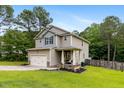 Charming two-story home with a two-car garage and well-kept lawn at 265 Tactical Dr, Bunnlevel, NC 28323