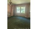 Bright living room with natural light and dated carpet at 5028 Valley View Dr, Sanford, NC 27330