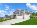 Charming two-story home with a three-car garage and well-maintained landscaping at 90 Stock Market Dr, Broadway, NC 27505