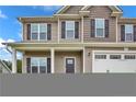Traditional two-story home with a covered porch and attached garage at 90 Stock Market Dr, Broadway, NC 27505