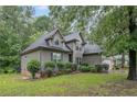 Charming home with gray shingle siding, landscaped front lawn, and attached two-car garage at 98 Pineridge Cv, Sanford, NC 27332
