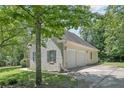 Side view of the home, showcasing a two-car garage and well-maintained surroundings at 110 Riviera Ln, Sanford, NC 27332