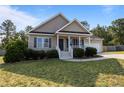 Inviting single-Gathering home showcasing a neat lawn, trimmed bushes, and a cozy covered front porch at 187 Gunner Ct, Broadway, NC 27505