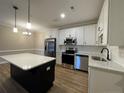Modern kitchen featuring stainless steel appliances, subway tile backsplash, and a center island at 220 Gallery Dr # 201, Spring Lake, NC 28390
