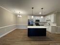 Bright kitchen with stainless steel appliances, subway tile backsplash, and a large kitchen island at 220 Gallery Dr # 201, Spring Lake, NC 28390