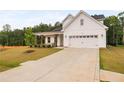 Attractive two-story home featuring white siding, an attached two-car garage, and a concrete driveway at 25 Vast View Way, Youngsville, NC 27596