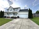 Charming two-story home featuring a two-car garage and meticulously manicured lawn at 554 Lenoir Dr, Spring Lake, NC 28390