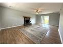 Spacious living room with a fireplace, wood flooring, and a sliding glass door to the backyard at 554 Lenoir Dr, Spring Lake, NC 28390