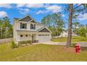 Well-maintained two-story house with a two-car garage, green lawn, and pleasant neighborhood setting at 1224 Micro Tower Rd, Lillington, NC 27546