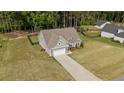 Aerial view of a single-Gathering home with a long driveway and a spacious, well-maintained lawn at 139 Ravens Row Dr, Benson, NC 27504