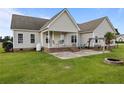 Spacious backyard featuring a patio, a swing, and a fire pit for outdoor entertaining at 140 Bagley Ln, Dunn, NC 28334