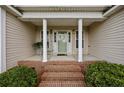 Inviting front porch with classic columns, brick steps, and charming details at 140 Bagley Ln, Dunn, NC 28334