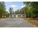 Inviting single-story home with a gravel driveway and lush trees in a quiet location at 2088 Heritage Way, Cameron, NC 28326