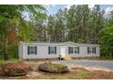 Cozy single-story home featuring a gravel driveway and natural surroundings at 2088 Heritage Way, Cameron, NC 28326