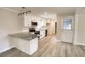 Modern kitchen features granite countertops, stainless steel appliances, and stylish white cabinetry at 374 S Denise Ave, Coats, NC 27521