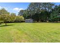Spacious backyard with a shed, ideal for outdoor activities and storage at 4001 Western Hills Dr, Sanford, NC 27330